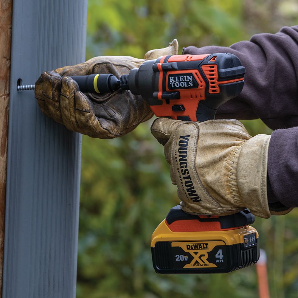 Person drilling into stone with a power drill.